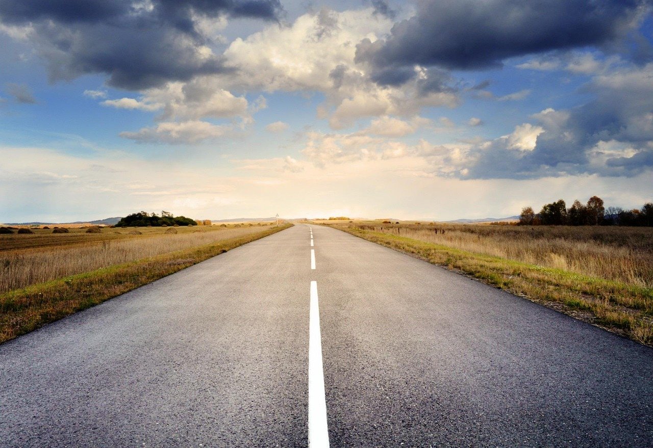 A wide, empty highway stretching into the horizon, symbolizing vast roadway coverage and efficient design.
