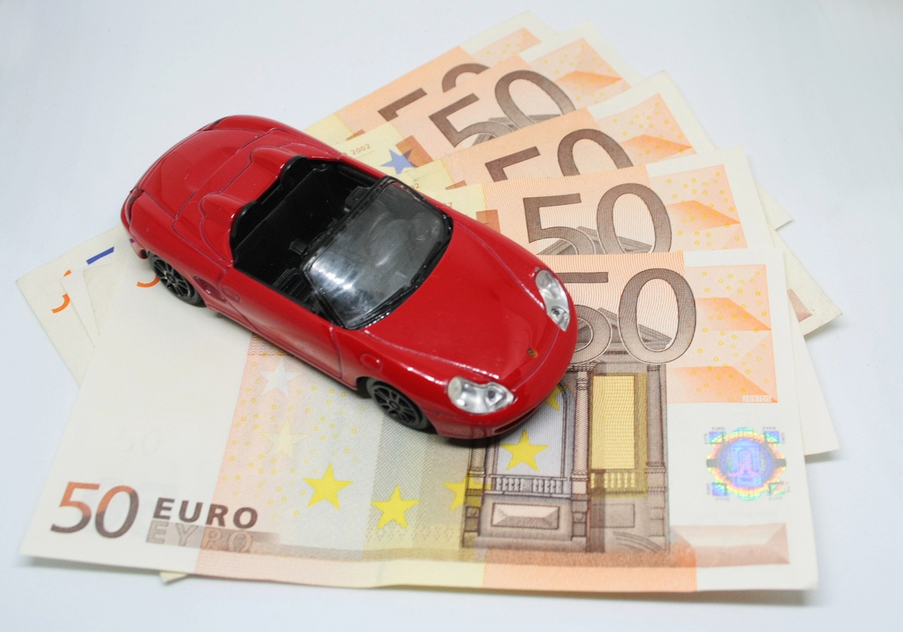 A sleek red toy car symbolizing the speed and accessibility of finding coverage com auto insurance.